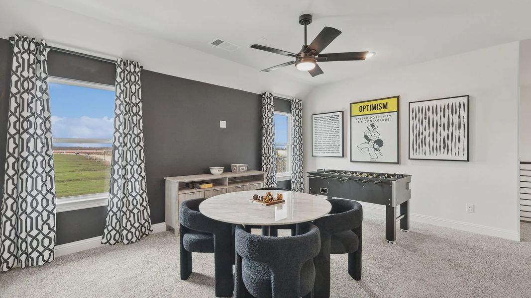 Luxurious game room with sleek ceiling fan, marble table, and panoramic views in North Texas. Luxurious game room with sleek ceiling fan, marble table, and panoramic views in North Texas.