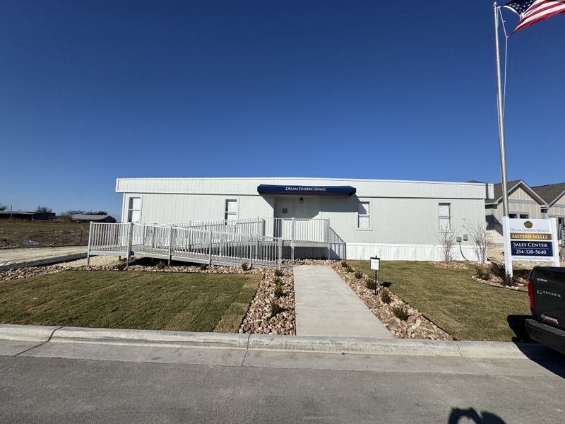 A modern sales center with a landscaped front in Eastern Wells by Dream Finders Homes (Jarrell, TX). A modern sales center with a landscaped front in Eastern Wells by Dream Finders Homes (Jarrell, TX).