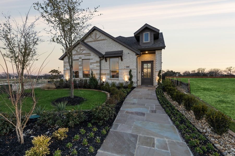 Front exterior of a home in the Redden Farms – Active Adult community, located in Midlothian, TX (Image 34).