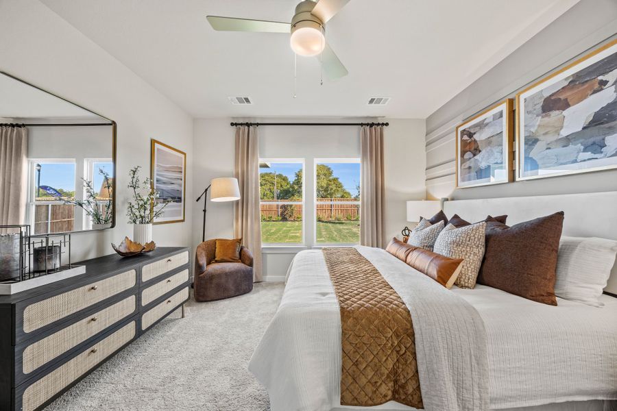 A bedroom with a large window.