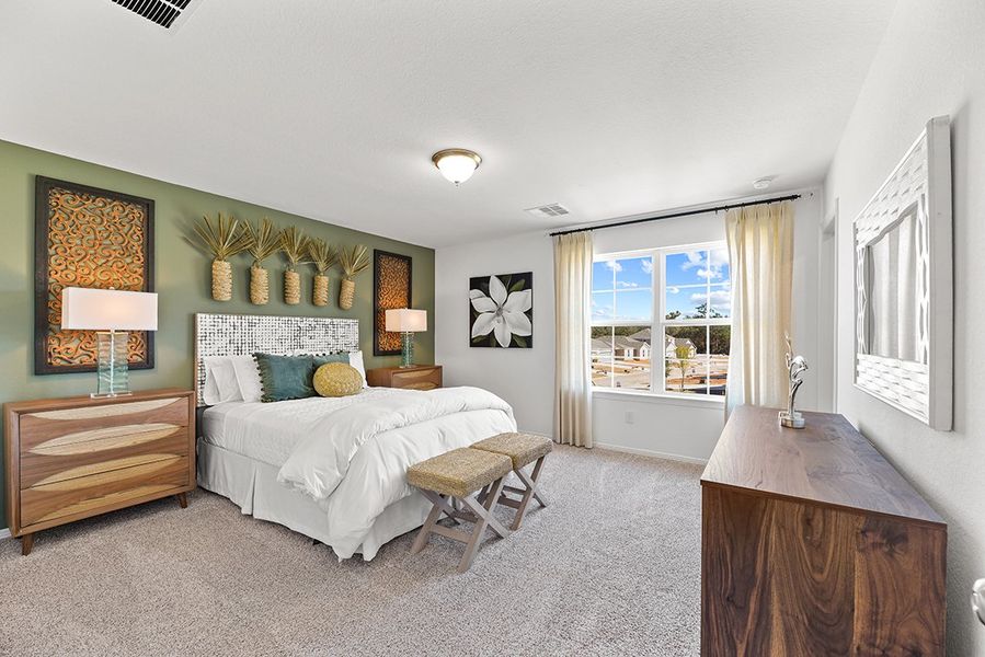 A bedroom with a bed and a desk. A bedroom with a bed and a desk.