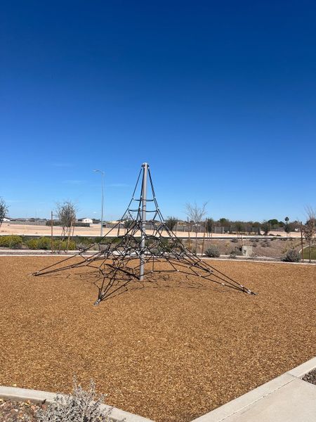 A modern playground with climbing structure in Estates at Estrella Crossing by Ashton Woods, Phoenix, AZ.