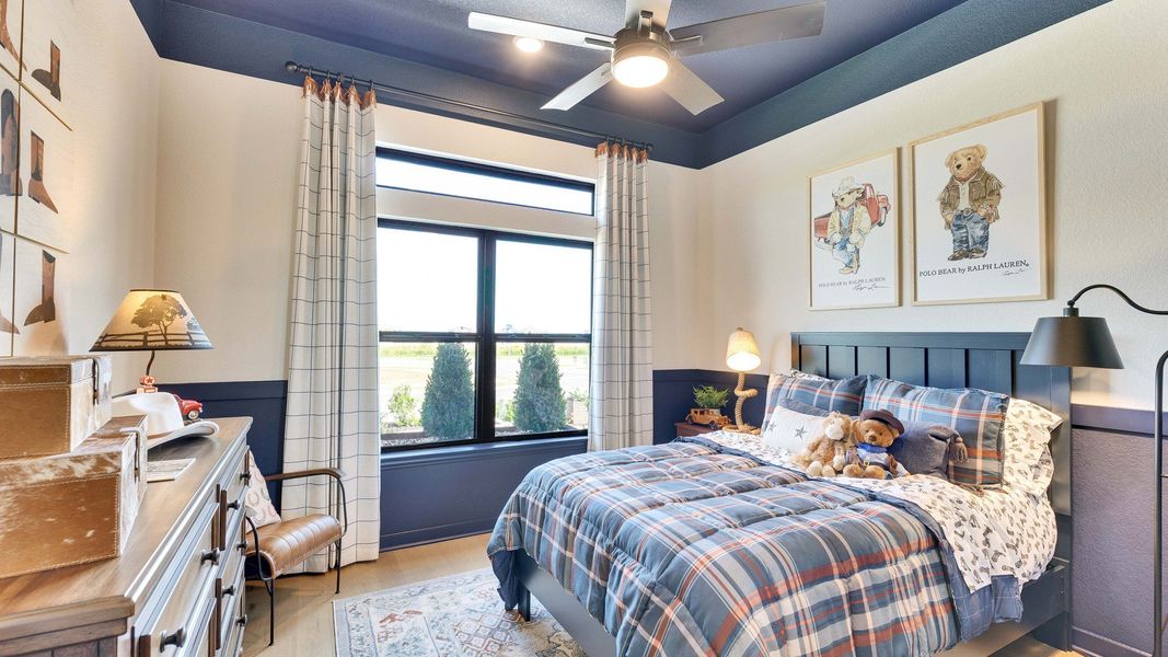 Features plaid bedding, cozy lighting, and expansive windows in Lakeside Meadows' refined dwelling. Features plaid bedding, cozy lighting, and expansive windows in Lakeside Meadows' refined dwelling.