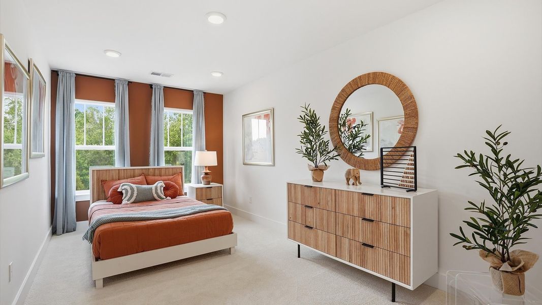 Tasteful bedroom with plush carpet, a walk-in closet, and large windows for abundant natural light at Marion Square