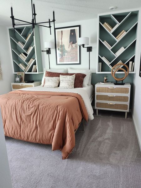 Cozy bedroom featuring built-in geometric shelves, warm bedding, and stylish lighting.