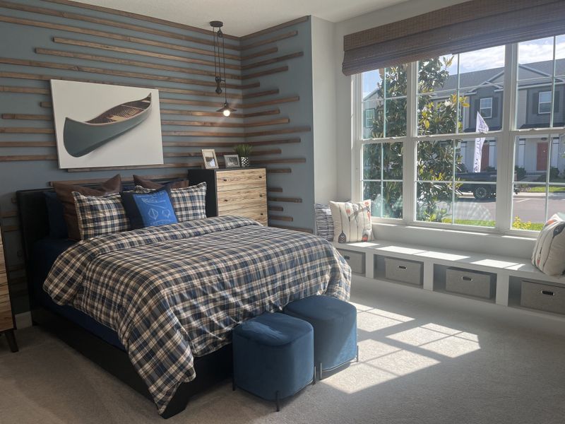 A cozy bedroom with plaid bedding, wood accents, a large window seat, and modern lighting. A cozy bedroom with plaid bedding, wood accents, a large window seat, and modern lighting.