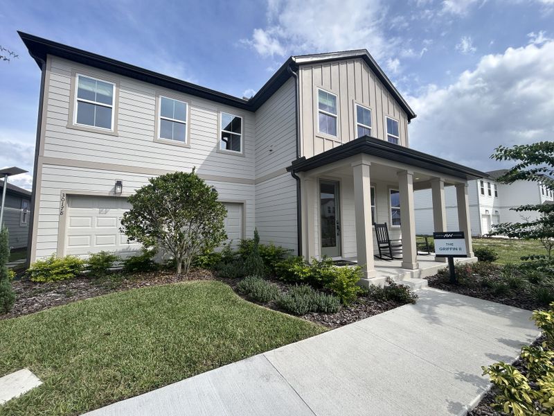 A modern two-story home with a lush yard in Trailside by Ashton Woods (Mount Dora, FL).