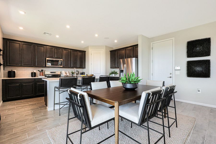 A kitchen with a dining table. A kitchen with a dining table.