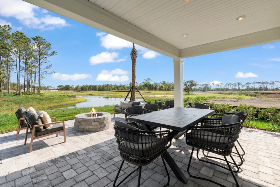 Kenai Model Home Covered Patio with Table and Chairs and Firepit at Reserve East in Flagler Beach Kenai Model Home Covered Patio with Table and Chairs and Firepit at Reserve East in Flagler Beach