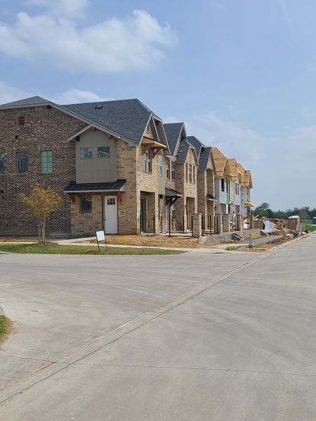 Newly built townhomes with stone exteriors in The Tribute by Grenadier Homes, The Colony, TX. Newly built townhomes with stone exteriors in The Tribute by Grenadier Homes, The Colony, TX.