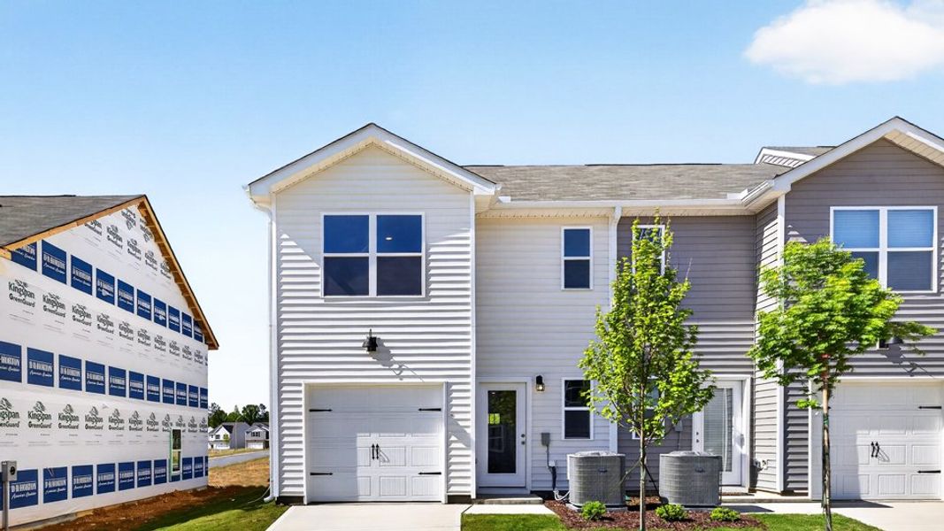 Front exterior of a home in the The Townes at Matthews Landing community, located in Fuquay Varina, NC (Image 11). Front exterior of a home in the The Townes at Matthews Landing community, located in Fuquay Varina, NC (Image 11).