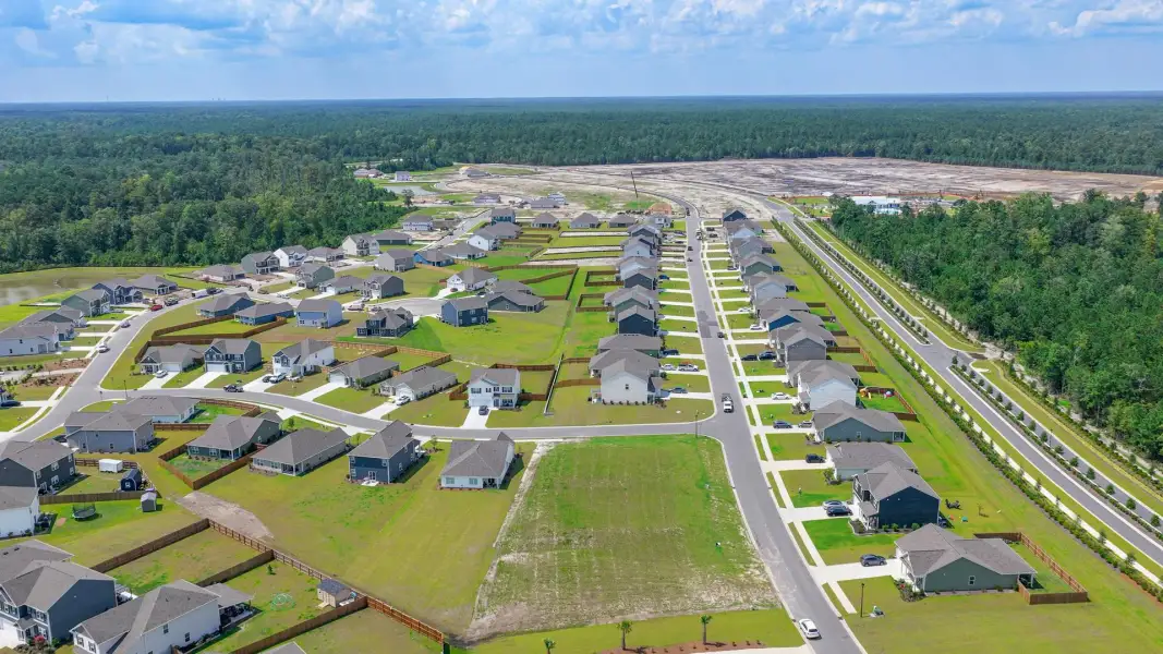 Aerial view of the The Highlands at Cedar Hill Landing community in Navassa, NC, showing layout and nearby surroundings (Image 13). Aerial view of the The Highlands at Cedar Hill Landing community in Navassa, NC, showing layout and nearby surroundings (Image 13).