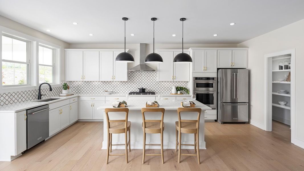 Gourmet kitchen boasts a large center island and stainless steel appliances Gourmet kitchen boasts a large center island and stainless steel appliances