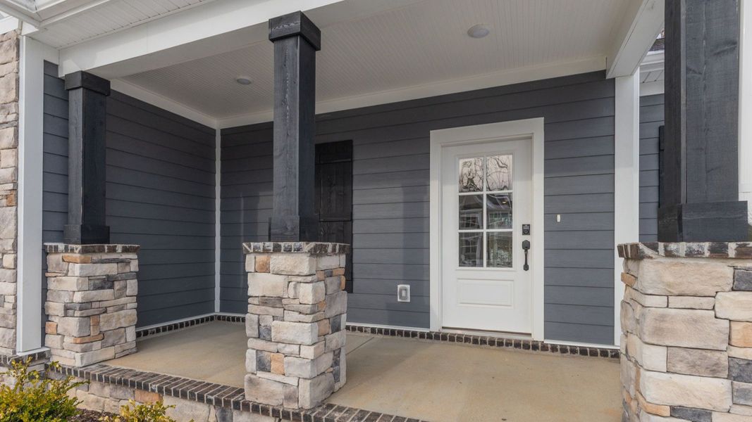 Covered front entryway with blue and stone accents Covered front entryway with blue and stone accents