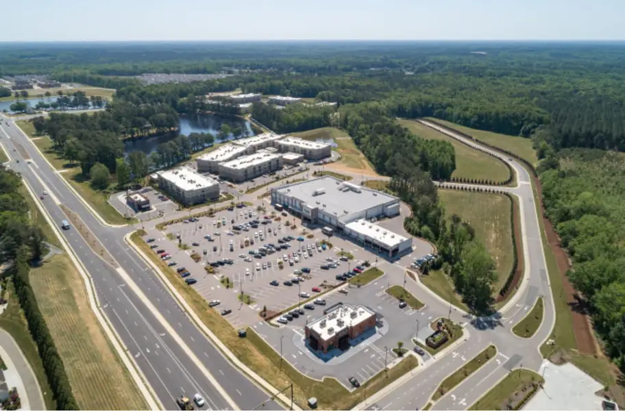 Aerial view of the South Lake Townes at Flowers Plantation community in Clayton, NC, showing layout and nearby surroundings (Image 15).