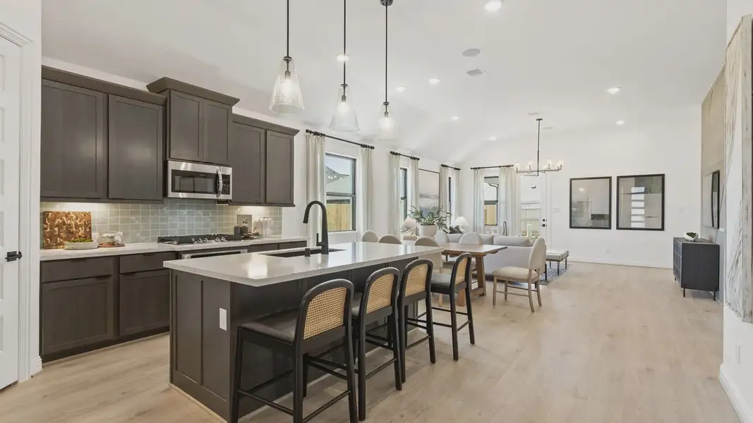 Elegant kitchen featuring high-end dark wood cabinetry and sleek countertops. Oakwood Estates. Elegant kitchen featuring high-end dark wood cabinetry and sleek countertops. Oakwood Estates.