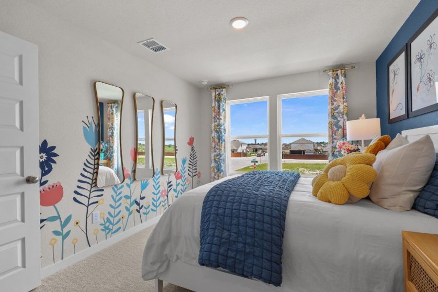 A bedroom with a bed and a window.