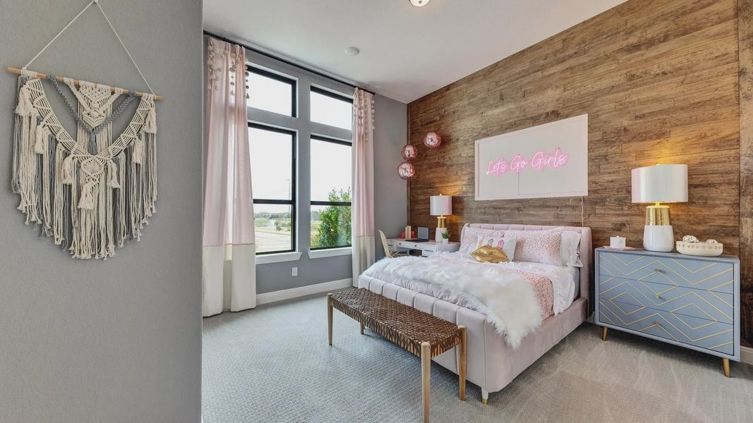Elegant wood paneling and expansive windows enhance this Hawkes Landing bedroom's refined style.