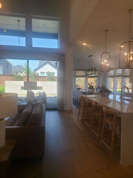 An inviting open-concept living space featuring high ceilings, abundant natural light, and modern finishes.