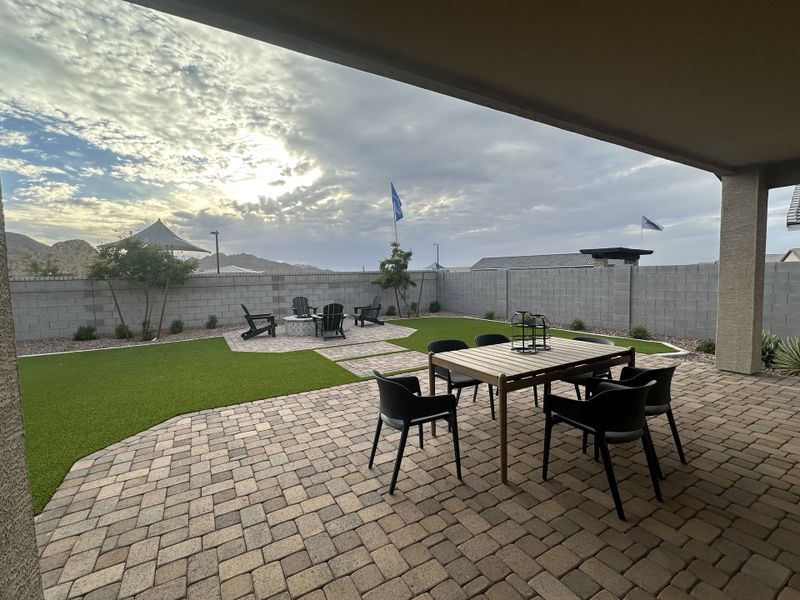 A spacious covered patio with paver flooring, perfect for outdoor dining and entertaining.