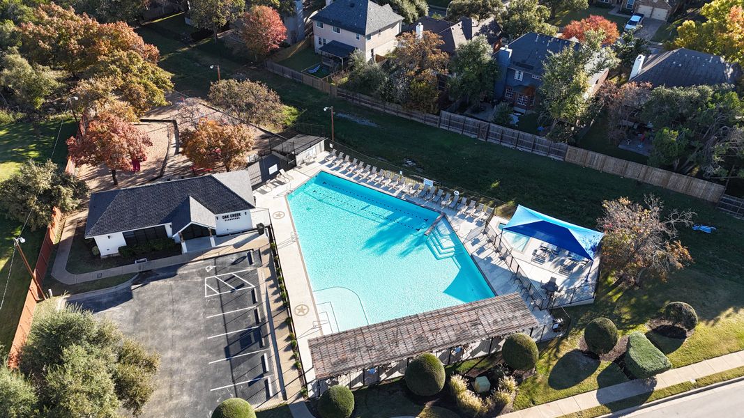 Aerial view of a community pool and clubhouse in Sauls Ranch East by Coventry Homes (Round Rock, TX).