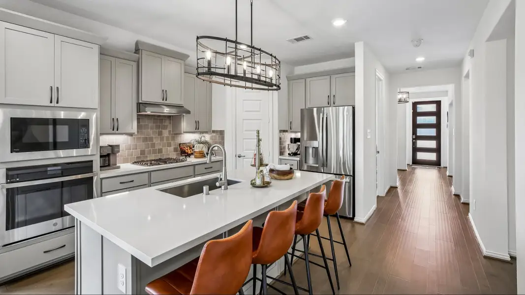 Cypress Green gem features elegant cabinetry, island bar, sleek pendant lighting, and luxurious hardwood floors. Cypress Green gem features elegant cabinetry, island bar, sleek pendant lighting, and luxurious hardwood floors.