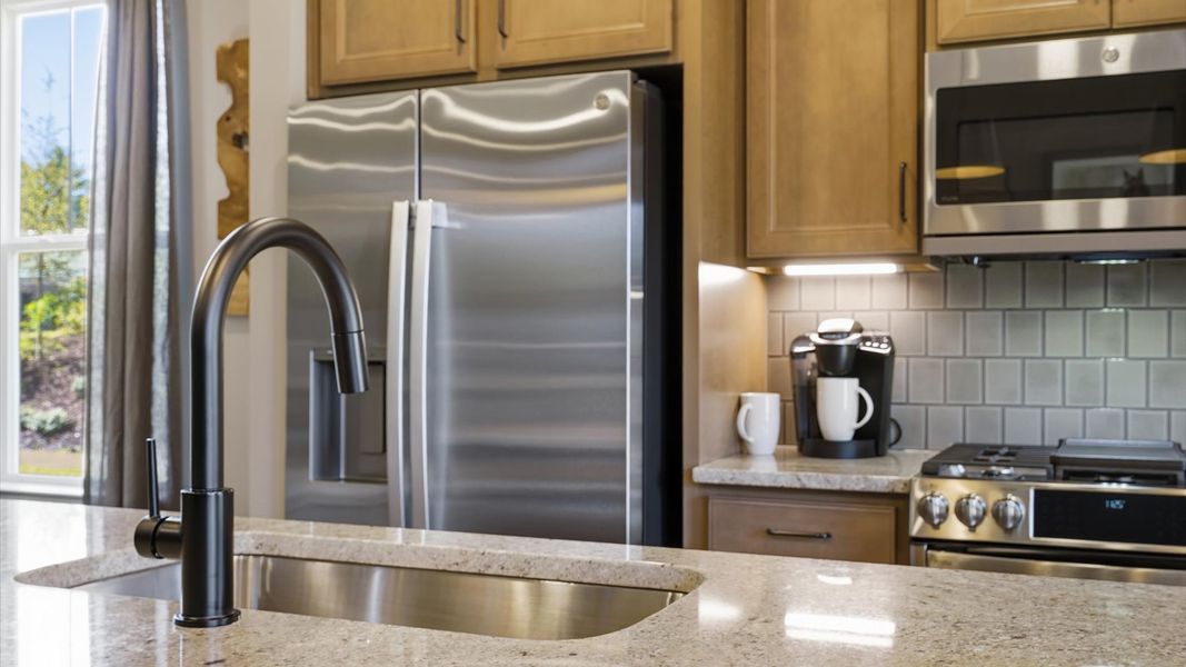 Tasteful kitchen with a streamlined island and modern finishes in a first-class DRB Homes design