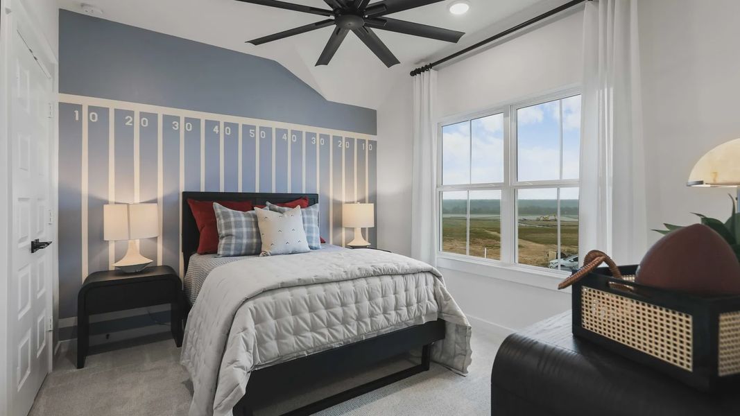 Revel in the sports-themed elegance and expansive window views in this Mostyn Springs bedroom. Revel in the sports-themed elegance and expansive window views in this Mostyn Springs bedroom.