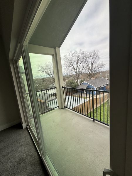 A cozy balcony with sleek railing and views of a serene yard, perfect for relaxation and enjoyment. A cozy balcony with sleek railing and views of a serene yard, perfect for relaxation and enjoyment.