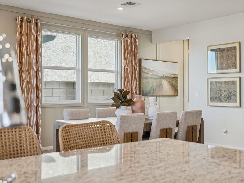A dining room with a table set.