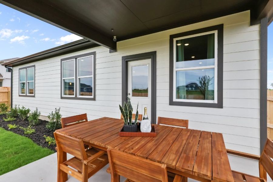 A table and chairs outside a house. A table and chairs outside a house.