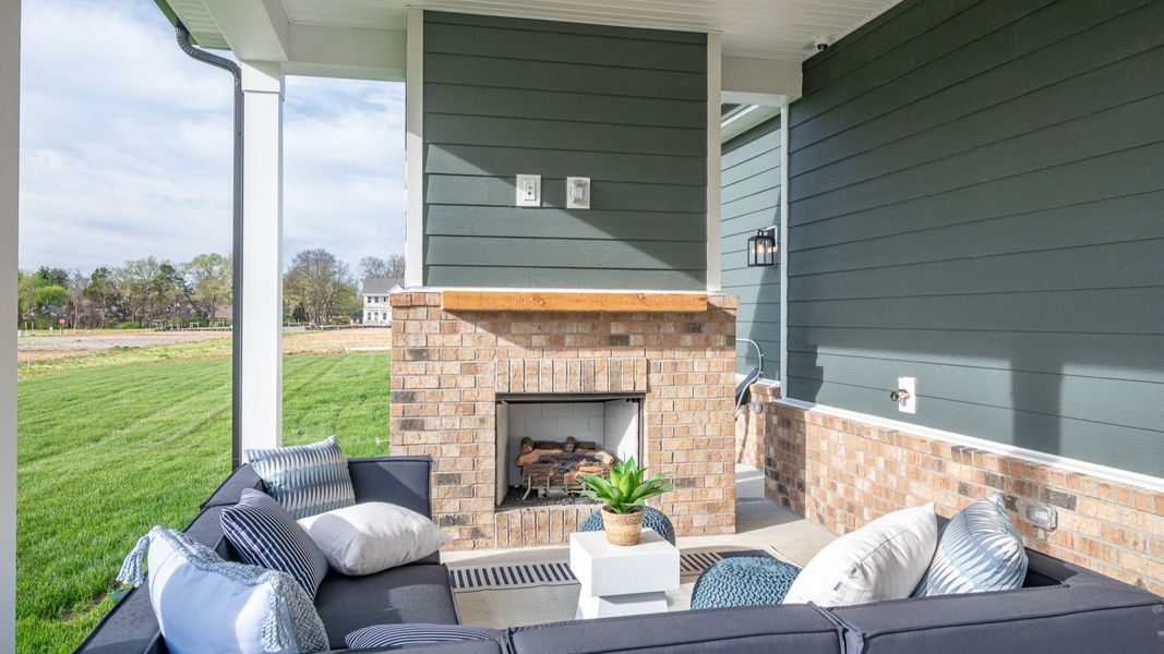 Covered rear patio with centered fireplace Covered rear patio with centered fireplace