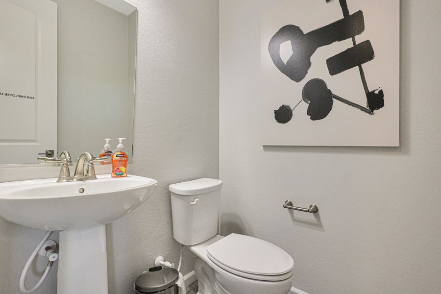 A bathroom with a toilet and sink. A bathroom with a toilet and sink.