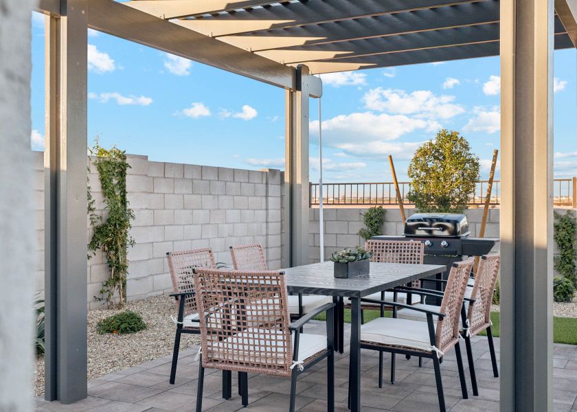 A table and chairs on a patio. A table and chairs on a patio.