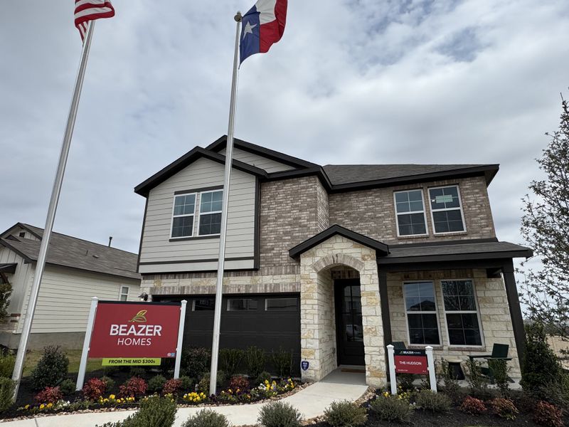 A modern stone and brick home with manicured landscaping in Hunter's Ranch by Beazer Homes, San Antonio, TX. A modern stone and brick home with manicured landscaping in Hunter's Ranch by Beazer Homes, San Antonio, TX.