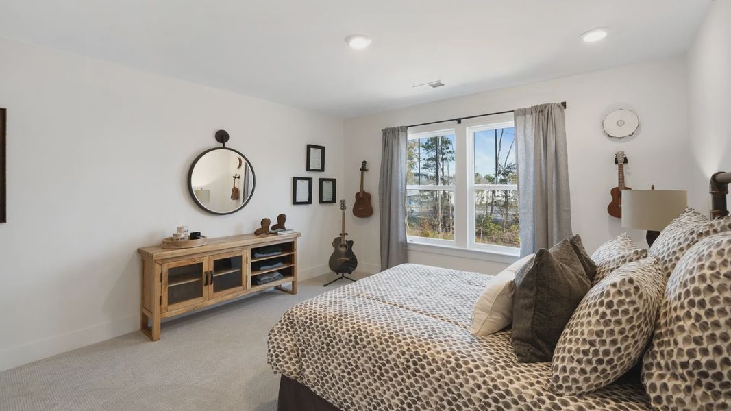 Very spacious secondary bedroom with carpeted flooring and large windows at Barton Hollow by DRB Homes in Fountain Inn, SC