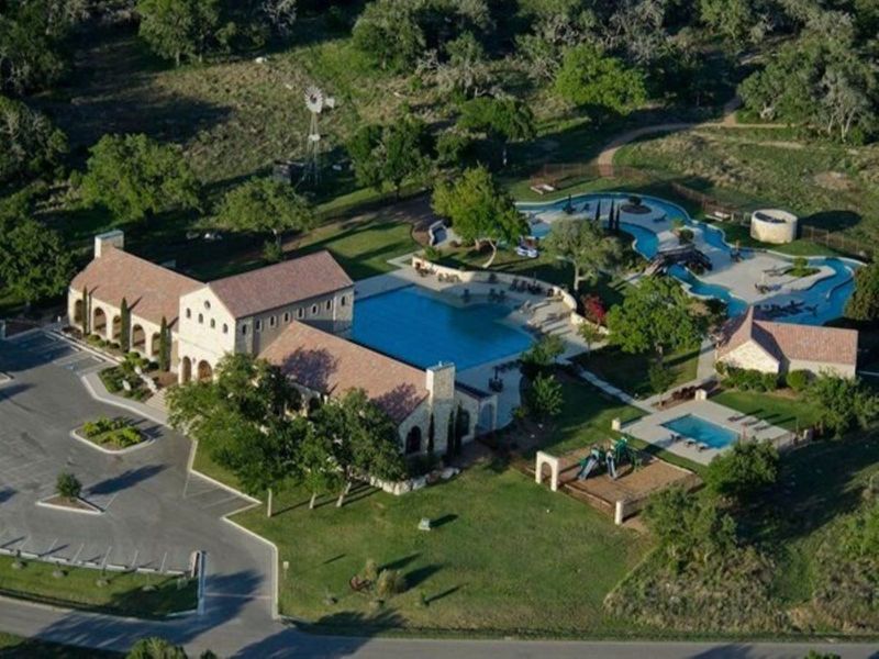 Aerial view of the The Grove at Vintage Oaks community in New Braunfels, TX, showing layout and nearby surroundings (Image 1).