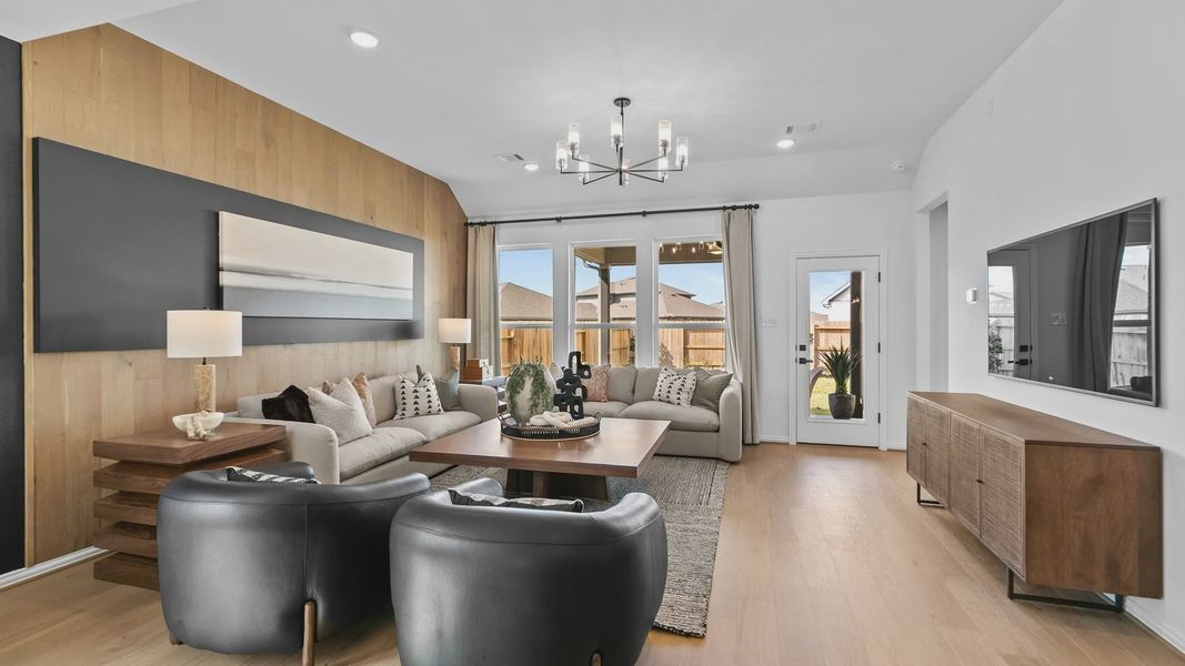 Elegant living room features wood accents and sleek lighting, offering style and comfort in River Ranch. Elegant living room features wood accents and sleek lighting, offering style and comfort in River Ranch.