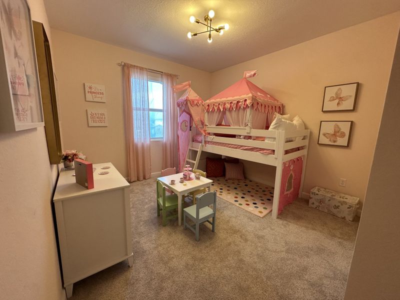 A charming children's room featuring a pink tent-themed bunk bed, playful decor, and soft lighting creating a cozy atmosphere.