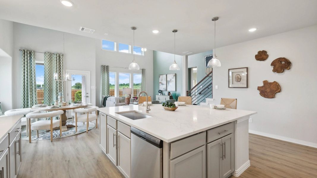 Expansive kitchen with marble countertops and elegant pendant lighting in Fort Worth's Hulen Trails. Expansive kitchen with marble countertops and elegant pendant lighting in Fort Worth's Hulen Trails.
