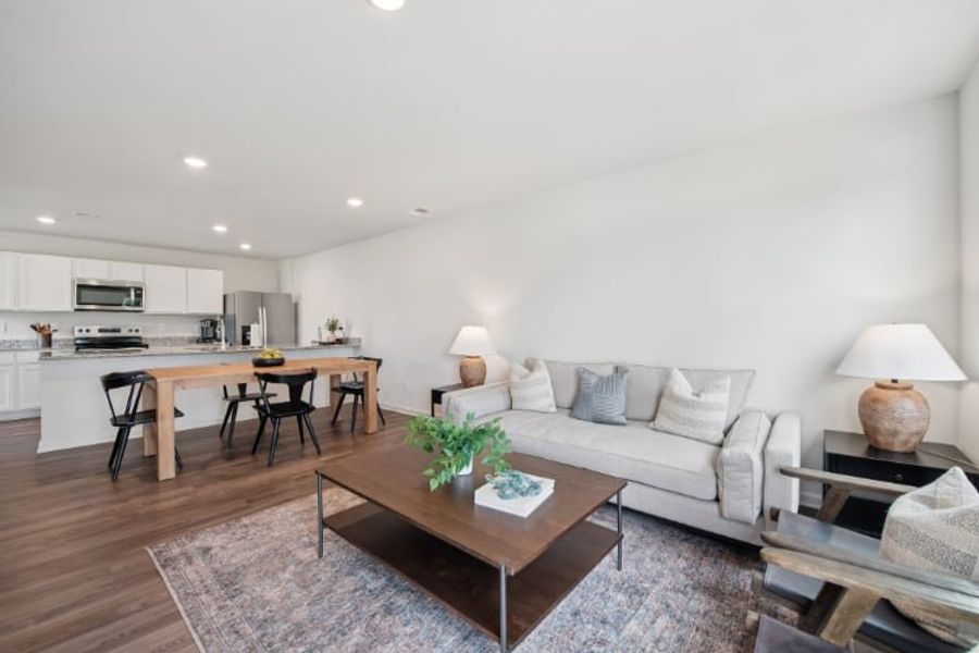 A living room with a couch and a table. A living room with a couch and a table.