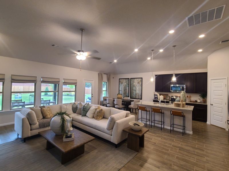 An inviting open-plan living area with a cozy sectional sofa, modern kitchen, and stylish decor, perfect for family gatherings. An inviting open-plan living area with a cozy sectional sofa, modern kitchen, and stylish decor, perfect for family gatherings.