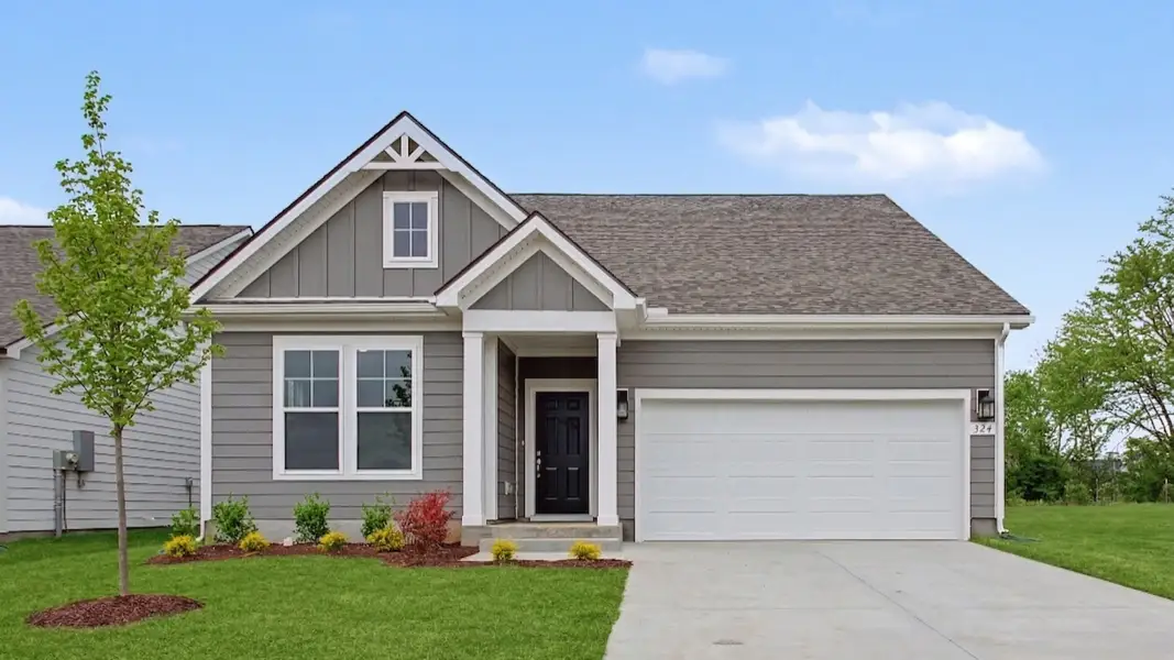 Exterior of single-story home with gray siding and accents and covered front entry