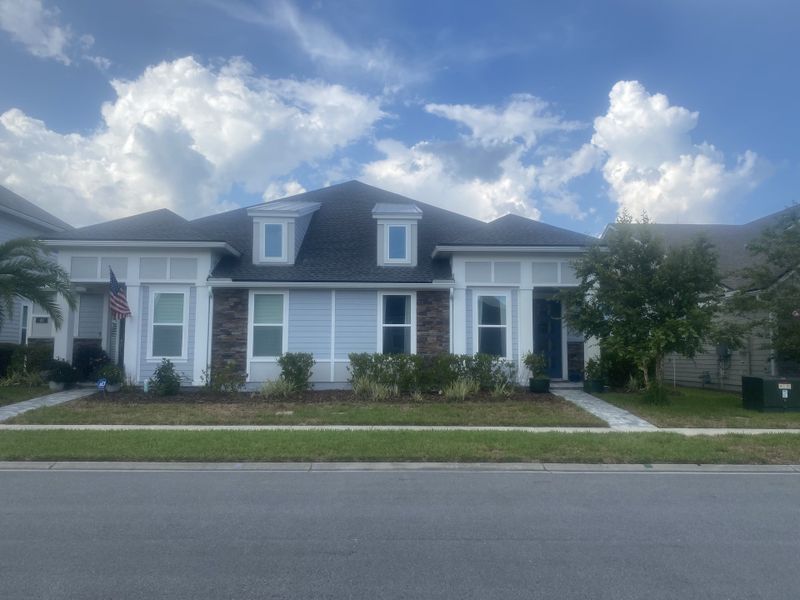 A charming home with a mix of stone and siding in West End At Town Center by Dostie Homes (Ponte Vedra Beach, FL). A charming home with a mix of stone and siding in West End At Town Center by Dostie Homes (Ponte Vedra Beach, FL).