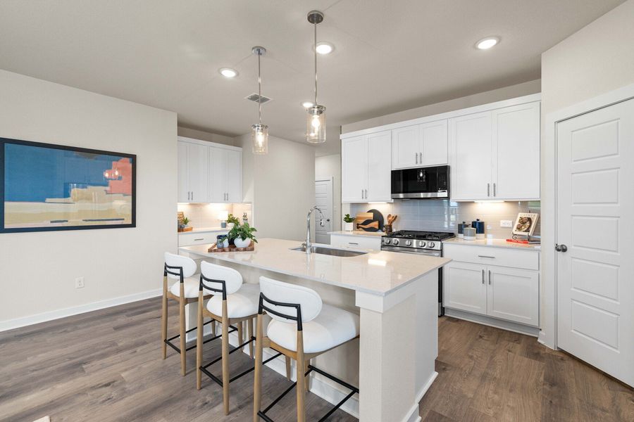A kitchen with white cabinets.
