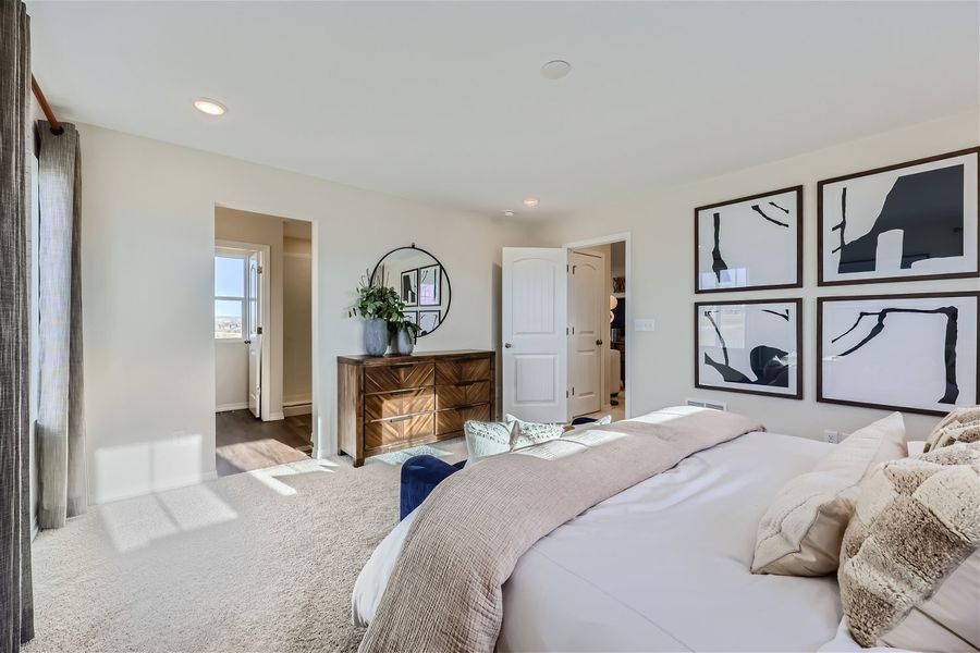 A bedroom with a bed and a mirror.