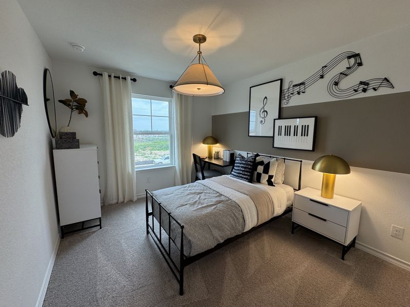 A modern bedroom featuring musical-themed decor, elegant lighting, and a cozy bed with patterned cushions.