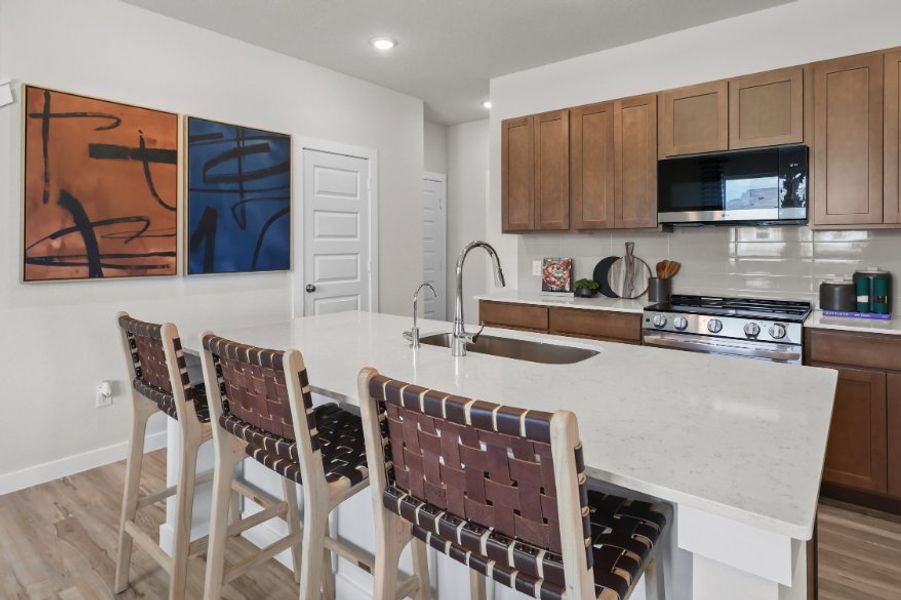 A kitchen with a table and chairs.