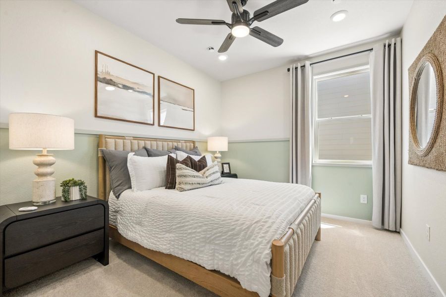 A bedroom with a bed and a fan. A bedroom with a bed and a fan.