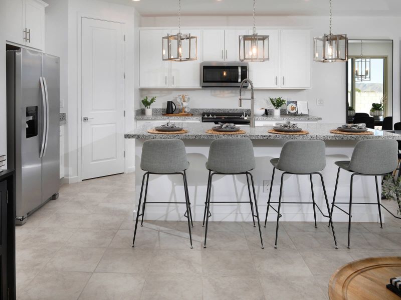 The oversized kitchen island provides ample prep space and casual seating.